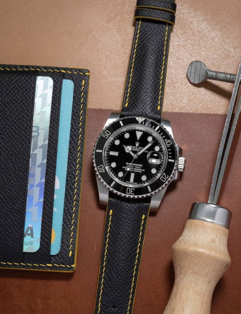 Sleek black Epsom leather with vibrant banana stitching and edge paint strap on Rolex